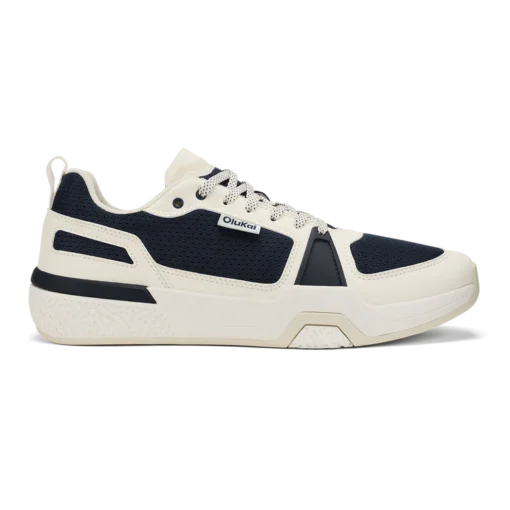 Olukai Men's ‘Anau Court Sneakers in mood indigo and bright white, featuring breathable mesh, arch support, and a high-traction rubber outsole for court play.